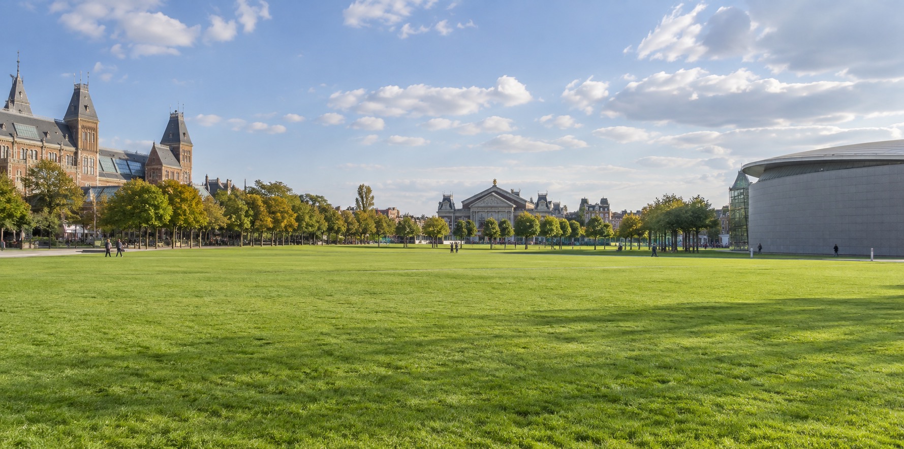 The open lawn of Museumplein in Amsterdam with museum buildings around it